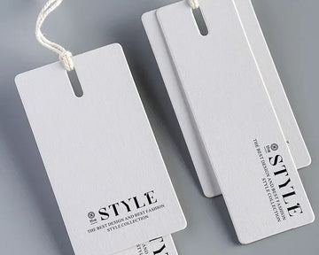 White product tags with 'STYLE' branding on a gray background