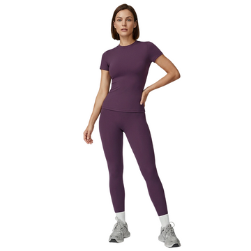 Woman wearing a purple athletic outfit on a white background
